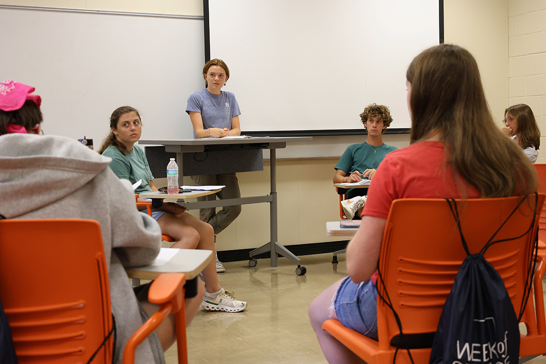 students in a classroom setting discussing items